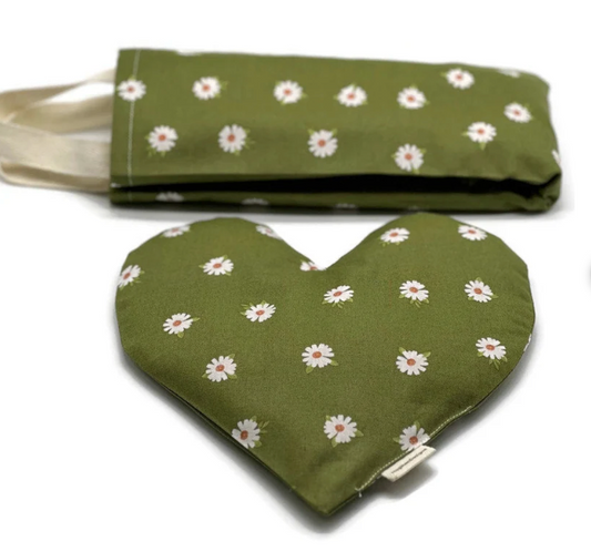 combo of a neckwrap and hearth shaped eye pillow with a green fabric with daisy pictures
